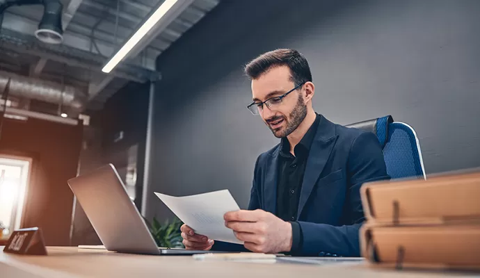 A professional accountant from W Advisory reviewing financial documents in a modern office — expert bookkeeping services in Sydney, Camden, Blacktown, Illawarra, and the Southern Highlands.